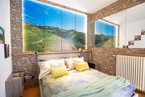 a bedroom with a bed with a large window at Appartamento Alba centro storico in Alba