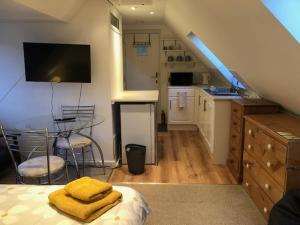a room with a kitchen and a dining room with a table at Hackamore House in Salisbury