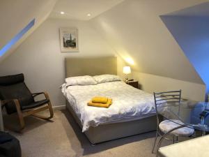 a bedroom with a bed with two yellow towels on it at Hackamore House in Salisbury