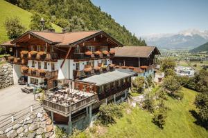 an aerial view of a building with a mountain at Jausenstation Pfefferbauer in Zell am See
