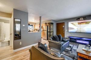 a living room with a leather couch and a tv at Easily Explore Anchorage! Modern Duplex Near Town in Alaska Regional Hospital Heliport