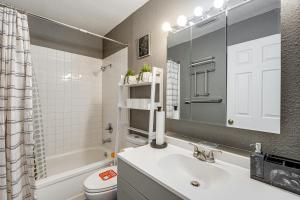 a bathroom with a sink and a toilet and a mirror at Easily Explore Anchorage! Modern Duplex Near Town in Alaska Regional Hospital Heliport +18 photos