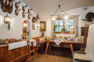 a dining room with a wooden table and a dining room at Jausenstation Pfefferbauer in Zell am See