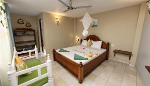 a small bedroom with a bed and a staircase at Green Oasis in Nungwi +35 photos