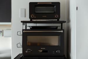 a microwave oven sitting on top of a stove at NIYS apartments 56type in Tokyo
