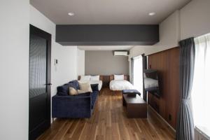 a living room with a couch and a bed at NIYS apartments 56type in Tokyo