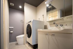 a bathroom with a sink and a washing machine at NIYS apartments 56type in Tokyo +25 photos
