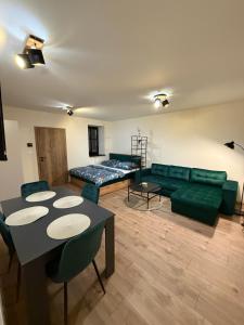 a living room with a couch and a table at Apartmán Mia 1 in Liptovský Mikuláš
