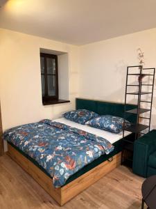 a bedroom with a bed and a ladder at Apartmán Mia 1 in Liptovský Mikuláš