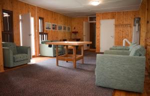 a living room with a table and two chairs at Jöekalda Accommodation in Pulli
