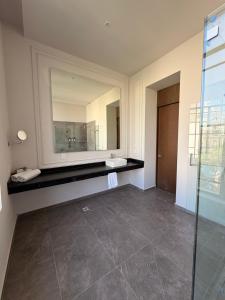 a bathroom with a sink and a mirror at Vista Catedral Guadalajara - Self Check in in Guadalajara +62 photos