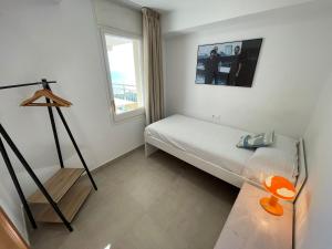 a small room with a bed and a window at Apartamento Terraza Mar in Malgrat de Mar +24 photos