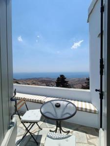 a balcony with a table and a view of the ocean at Terpsithea in Triandáros