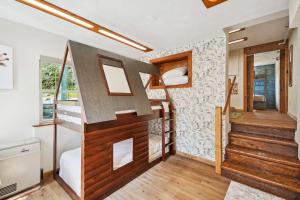 a tiny house with a staircase and bunk beds at Myrtle Villa 7BR Near Mount Snow with Indoor Heated Endless Style Pool Outdoor Hot Tub in Dover +40 photos