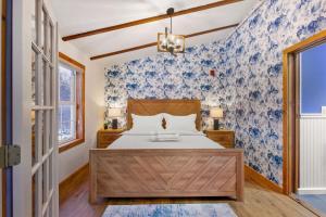 a bedroom with a bed with blue and white wallpaper at Myrtle Villa 7BR Near Mount Snow with Indoor Heated Endless Style Pool Outdoor Hot Tub in Dover