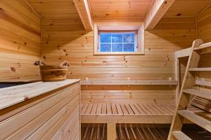 a sauna in a log cabin with a window at Myrtle Villa 7BR Near Mount Snow with Indoor Heated Endless Style Pool Outdoor Hot Tub in Dover