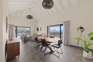a dining room and living room with a table and chairs at Penthouse Casa James, Mambo Beach, Jacuzzi & Sea View in Willemstad