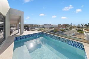 a swimming pool in the middle of a house at Penthouse Casa James, Mambo Beach, Jacuzzi & Sea View in Willemstad
