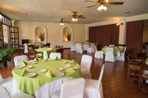 a banquet hall with green and white tables and chairs at Hotel La Loma Tepic in Tepic
