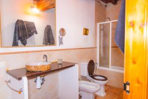 a bathroom with a toilet and a sink at Casa Rural Mirabueno in Cuenca +83 photos