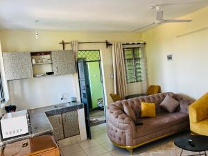 a living room with a couch and a table at Figtree 1bedroom by kiv in Kilifi +8 photos