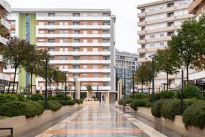 a walkway in the middle of a city with buildings at Fratello Apartment in Podgorica