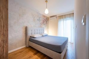 a bedroom with a bed in a room at Fratello Apartment in Podgorica