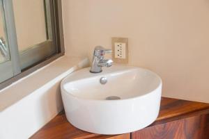 a white sink in a bathroom with a window at Newly renovated apartment with pool in Santa Cruz Huatulco +9 photos