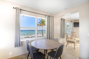 a dining room with a table and chairs and a view of the beach at La Terrace Oceanfront in Hollywood