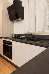 a kitchen with a sink and a stove at Harmony House in Castellana Grotte +6 photos