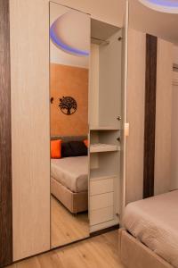 a mirror in a small room with a bed at Harmony House in Castellana Grotte