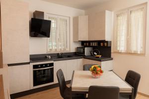 a kitchen with a table with a bowl of fruit on it at Harmony House in Castellana Grotte