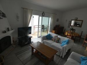 a living room with a couch and a coffee table at Casa Caracol in Praia do Carvoeiro