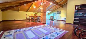 a living room with a table and a rug on the floor at La Casona y El Apartamento De La Foz in Lugar de Arriba