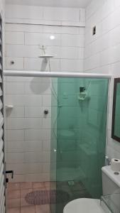 a glass shower in a bathroom with a toilet at Pousada Palladium in Neópolis