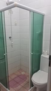 a bathroom with a glass shower with a toilet at Pousada Palladium in Neópolis +2 photos