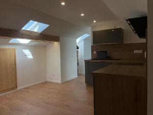 a kitchen with skylights and a counter in a room at Charmantes Dorf-Apartment in Dietramszell +19 photos