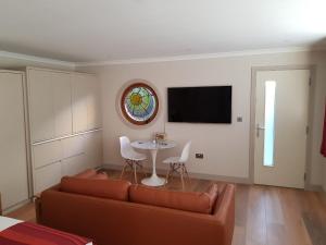 a living room with a couch and a table at Anchors Aweigh in Stanley