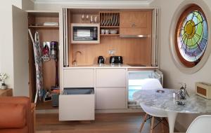 a kitchen with white cabinets and a table and a window at Anchors Aweigh in Stanley
