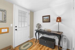 a room with a desk with a lamp and a door at Easy Street Cottage in Rockaway Beach +12 photos