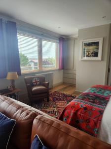 a living room with a couch and a chair at Anchors Aweigh in Stanley