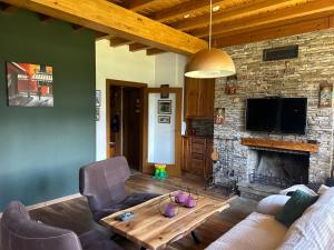a living room with a couch and a fireplace at Katarino Villa Nature Escape in Razlog