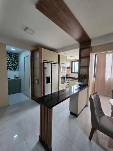 a large kitchen with a large black counter top at Tulipanes 901 in Ciudad del Este