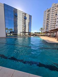 a large swimming pool in front of a building at Tulipanes 901 in Ciudad del Este