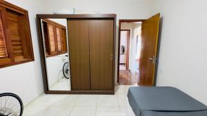 a room with a mirror and a door with a bike at Jardim dos Ipês in Araranguá