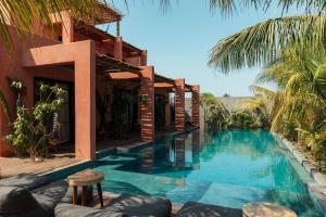a swimming pool in front of a house at Swell in El Paredón Buena Vista