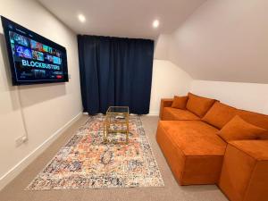 a living room with a couch and a flat screen tv at Premium Apartment with Dover Castle Views, Central Dover in Dover