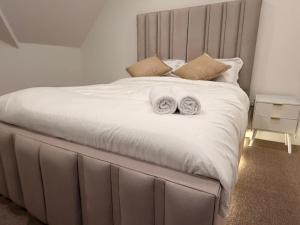 a bed with two towels on top of it at Premium Apartment with Dover Castle Views, Central Dover in Dover