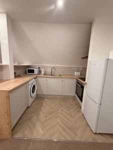 a kitchen with a white refrigerator and a dishwasher at Premium Apartment with Dover Castle Views, Central Dover in Dover