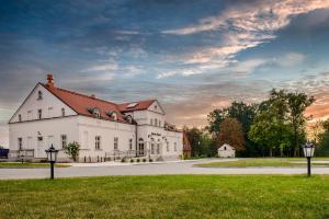 a large white building with a red roof at Hotel Dwór Fijewo in Golub-Dobrzyń